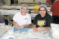Kathleen Boehme, left, and Katrine Aboujaoude make meat pies ahead of the Lebanese Food and Cultural Festival on April 12-13.