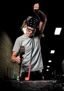 Joseph Harris works to shape hot iron for a fence. (Journal photo by Lee Walls Jr.)