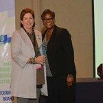 Maggie Brooke, left, accepts the W. Clement Stone Outstanding Achievement Award for Loraine Orr. (Photo special to the Journal)