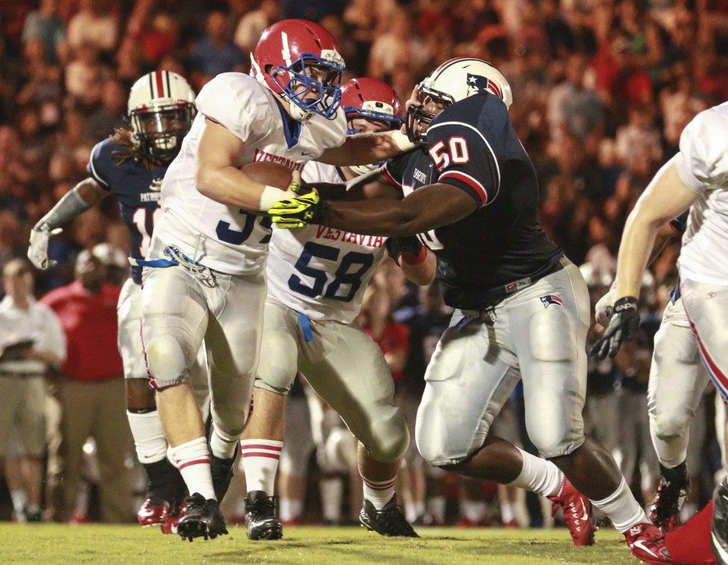 Vestavia Hills' Thomas Minor pushes away Homewood's Griffin Gentry during the game at Waldrop Stadium. Journal photo by Marvin Gentry