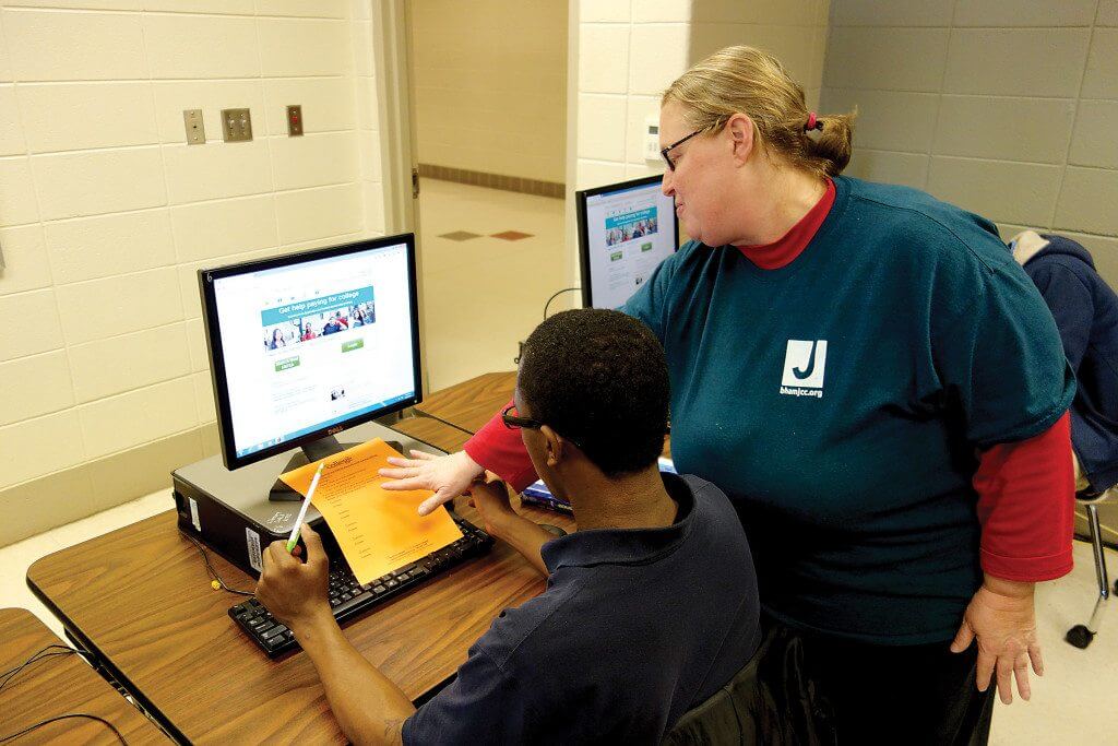 Stephanie Beacham, Vestavia Hills, helps a Wenonah High School senior complete his FAFSA for financial aid. Photo by Sarah Kuper.