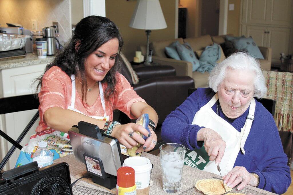 Caraline Sbriss and her grandmother help make pizzelles.