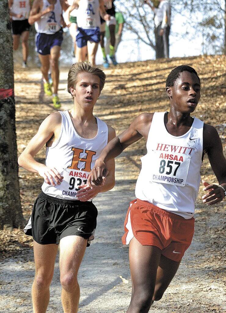 Hoover's Tommy McDonough (931) and Hewitt-Trussville's John Ngaruiya (857) compete in the boys' Class 7A race n the Alabama High School Athletic Association's 2016 State Cross Country Championships in Oakville, Ala. Saturday. (Photo by Todd Thompson/RiverCat Photography)